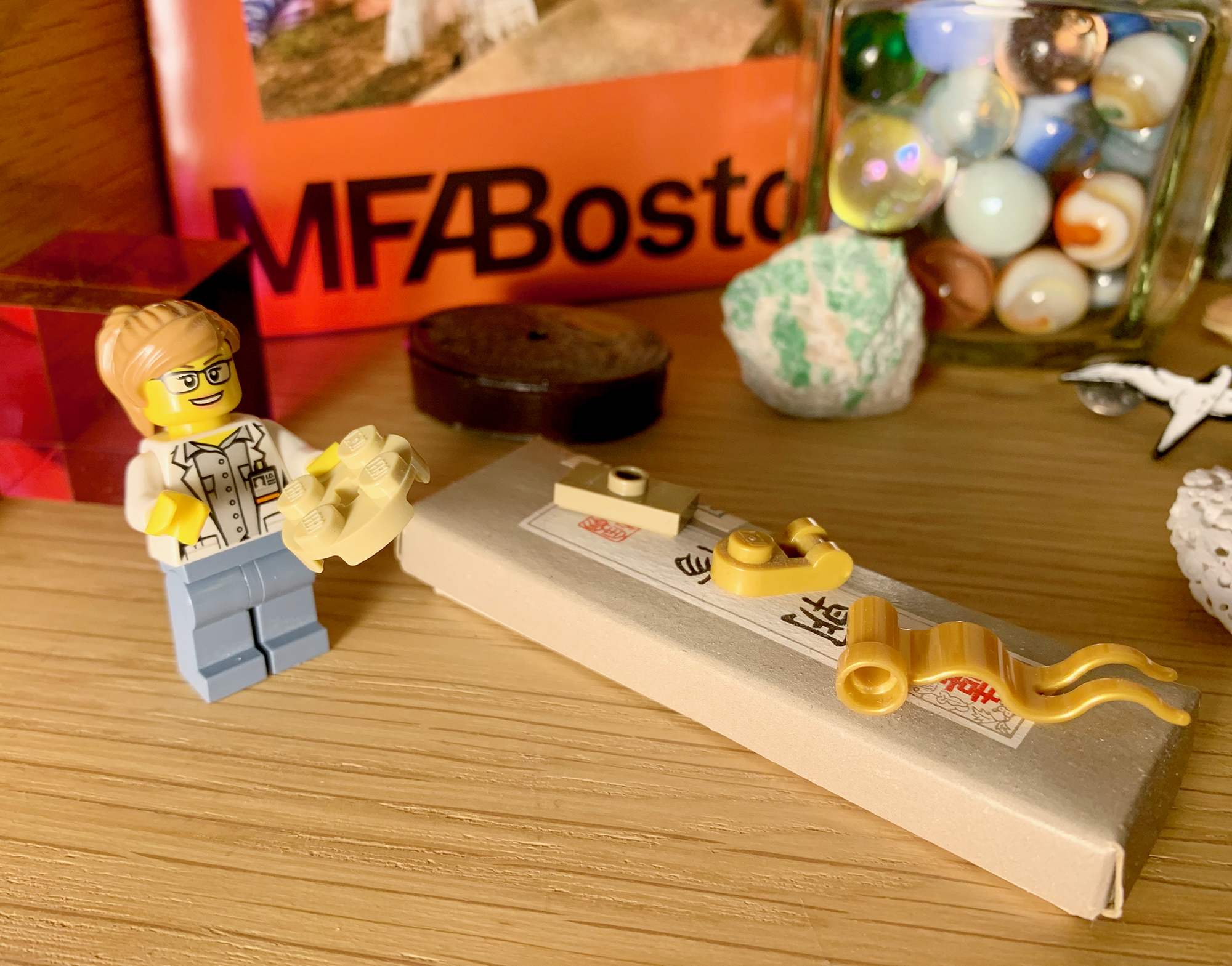 A Lego model of the paper conservation lab— complete with Ellory’s mom standing before a long table containing several artifacts.